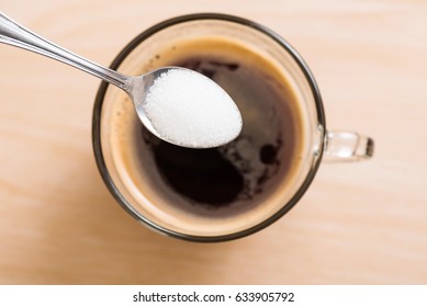 Pouring Sugar Into Coffee Cup