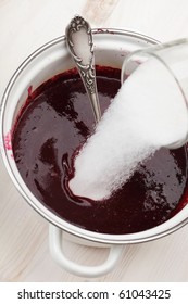 Pouring Sugar Into The Pan With Black Currant Syrup