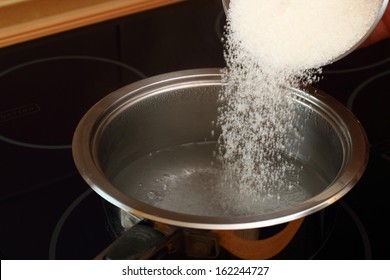 Pouring Sugar Into Saucepan With Boiling Water. Candied Orange Zest Cooking. Series.