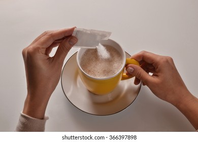 Pouring Sugar On Coffee Cup.