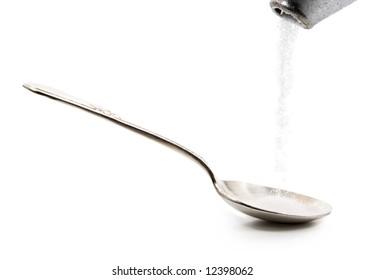 Pouring Sugar In A Silver Spoon, Isolated On White