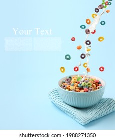 Pouring of tasty cereal rings and milk into bowl on color background with space for text - Shutterstock ID 1988271350