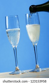 Pouring Two Glasses Of Sparkling Italian Prosecco Wine In Summer.