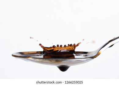 Pouring Vanilla Extract On A Spoon