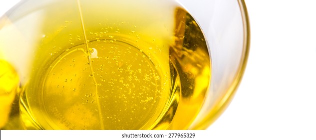 Pouring Vegetable Cooking Oil Into A Clear Glass Bowl 