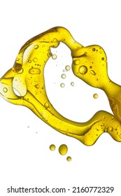 Pouring Vegetable Oil With Bubbles Isolated On White Background.