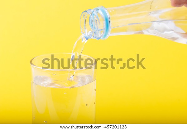 Download Pouring Water Blue Bottle Glass Yellow Stock Photo Edit Now 457201123 Yellowimages Mockups