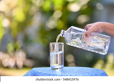 Pouring Water From A Bottle Into A Glass