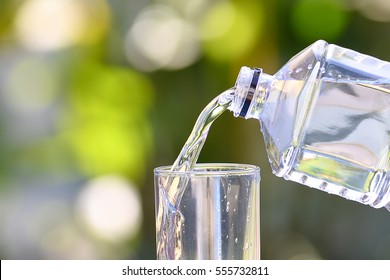 Pouring Water From A Bottle Into A Glass