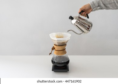 Pouring Water  To The Coffee Pot On White Wall And White Table, Manual Brew, Hand Drip Coffee