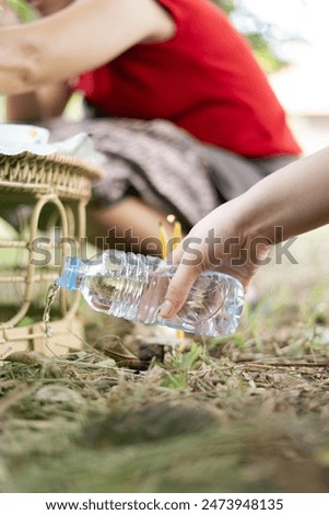 Pouring water of dedication, or making a libation in Buddhism