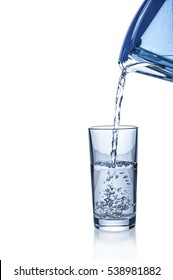 Pouring Water From Filter Pitcher In Glass On White Background