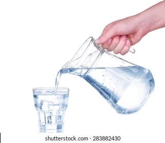 Pouring Water From Glass Pitcher On White Background