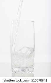 Pouring Water Into A Glass Half Full