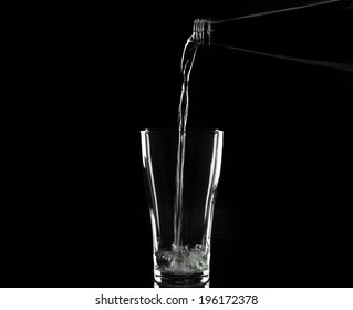 Pouring Water On Glass On Black Background