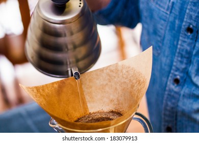 pouring water over coffee grounds