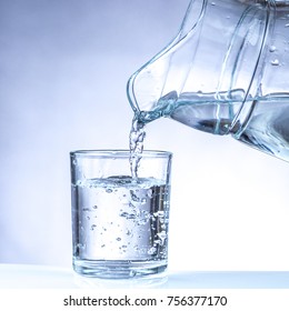 Pouring Water From Pitcher Into A Glass