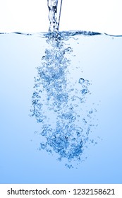 Pouring water splash with air bubbles in blue white water background