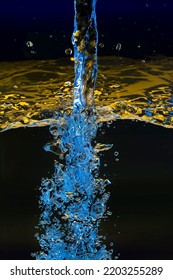 Pouring Water.colored Jet On A Dark Background