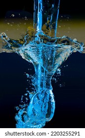 Pouring Water.colored Jet On A Dark Background