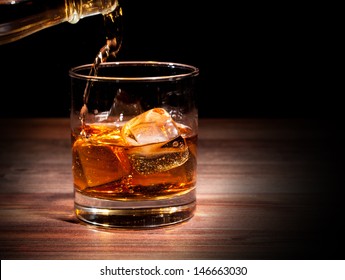 Pouring Whiskey Drink Into Glass