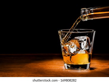 Pouring Whiskey Drink Into Glass