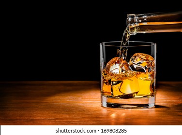 Pouring Whiskey Drink Into Glass