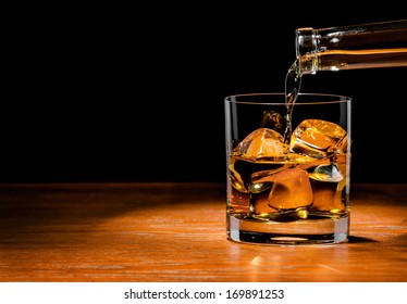 Pouring Whiskey Drink Into Glass