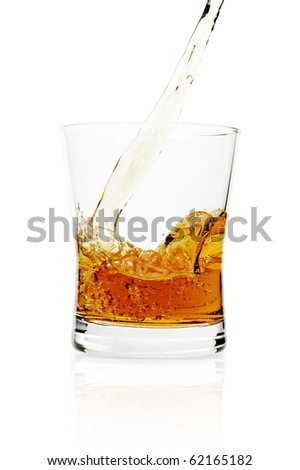 Pouring whiskey in glass, isolated on white