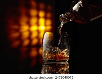 Pouring whiskey into a glass on a black background. Copy space. - Powered by Shutterstock