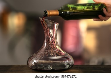 Pouring Wine In Carafe On Blurred Background