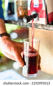 Pouring Wine In Glass From 3l Wine Box Close Up Outdoors