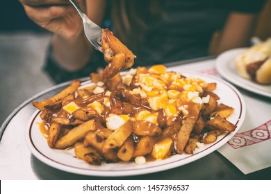 Poutine French Fries Canadian Local Classic Dish In The Province Of Quebec, Canada. Fast Food Retro Diner Restaurant Serving Plate Of Fried Potates With Brown Gravy Sauce And Fresh Cheese Curds.