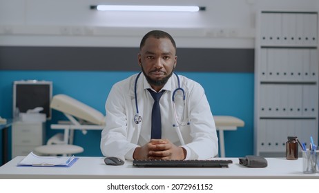 Pov Of African American Therapist Doctor Listening Remote Patient During Online Videocall Meeting Confrence In Hospital Office. Physician Man Explaining Medication Treatment. Telehealth Call Concept