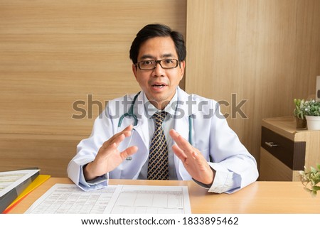 POV Asian man doctor talking with patient via video call conference, telehealth or telemedicine concept