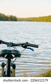 POV Bike Handlebar With A Nature Backdrop. Leisure Time In Summer Evening Concept.