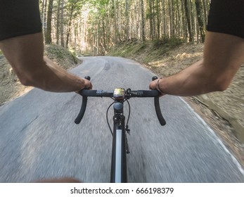 Pov Cycling. Young Adult Man Riding A Racing Bicycle On A Mountain Road In A Forest. Personal Perspective