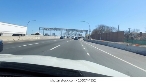 POV Driving Forward View Passing Cashless Toll Sensors Before Crossing Throgs Neck Bridge In New York City.