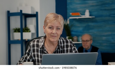 POV Of Elderly Aged Woman Waving During A Video Conference With Business Partners Working From Home. Senior Person Using Internet Online Chat Technology Webcam Making Virtual Meeting Call Connection