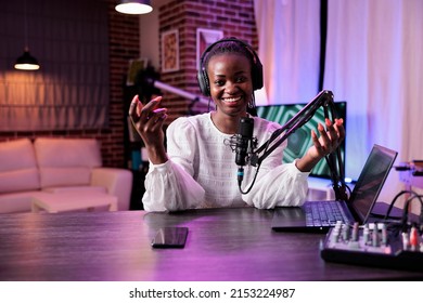 POV of female presenter greeting people on channel podcast, using camera and recording equipment in studio. Lifestyle vlogger talking to audience on social media episode, internet content.