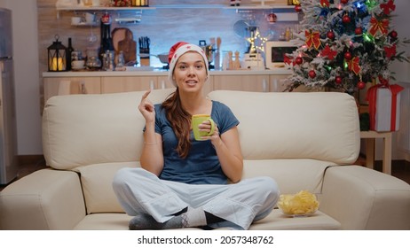 POV Of Festive Woman Talking On Video Call With Family On Christmas Eve. Person Using Online Conference On Internet For Remote Holiday Celebration While Looking At Camera And Chatting