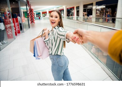 Pov first person point view portrait of her she nice attractive lovely charming positive cheerful cheery girl holding in hands bags walking having fun leading guy walking retail store