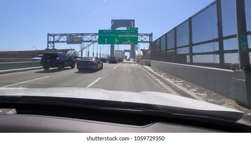 POV Front Windshield Car View On Thogs Neck Bridge In New York City Driving In Traffic During Day Time. 