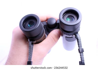 POV Hand Holding Pair Of Binoculars Isolated On White Background