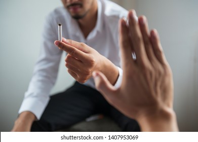 POV Hand Making Reject Or Refuse Sign For Cigarette From Friend. Can Use For Quit Smoking Or World No Tobacco Day Concept.