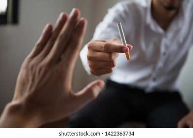 POV Hand making reject or refuse sign for cigarette from friend. Can use for quit smoking or world no tobacco day concept. - Shutterstock ID 1422363734