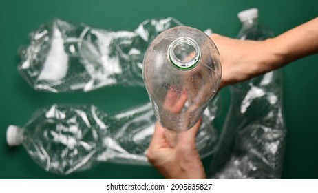 POV Hands Crumple And Crush Plastic Pop Bottle For Recycling. Crumpled Plastic Bottles Ready For Recycle. First Point View Preparation Of Recycled Household Trash As Zero Waste