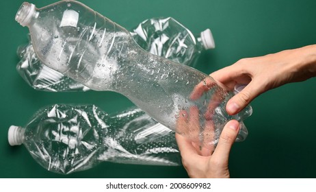 POV Hands Crumple And Crush Plastic Pop Bottle For Recycling. Crumpled Plastic Bottles Ready For Recycle. First Point View Preparation Of Recycled Household Trash As Zero Waste