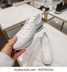 POV Male Hand Choosing A New White Sneakers In The Shoes Store