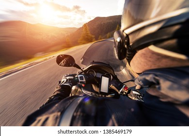 POV Of Motorcycle Driver Riding On Alpine Road. Outdoor Photography. Travel And Sport, Speed And Freedom Concept